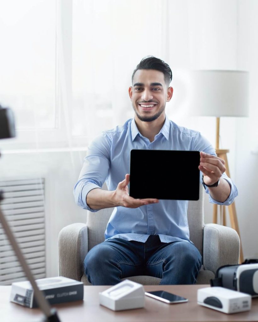 arab-male-influencer-shooting-video-review-of-modern-tablet-computer-on